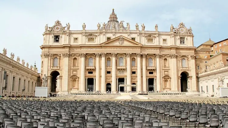 Exterior da Basílica de São Pedro no Vaticano com cadeiras posicionadas para missa