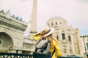Mulher em viagem, fazendo passeio turístico. Você consegue comprar ingressos para a sua viagem no Civitatis.