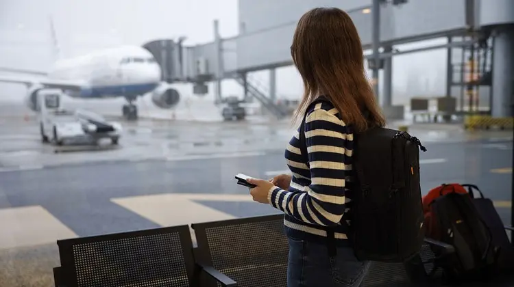 Mulher em aeroporto, esperando por voo.