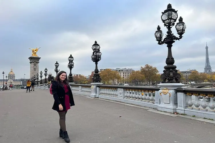 Mulher em ponte com candelabros ao fundo