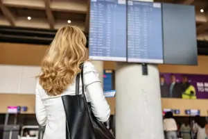 Passageira olhando para painel de voos