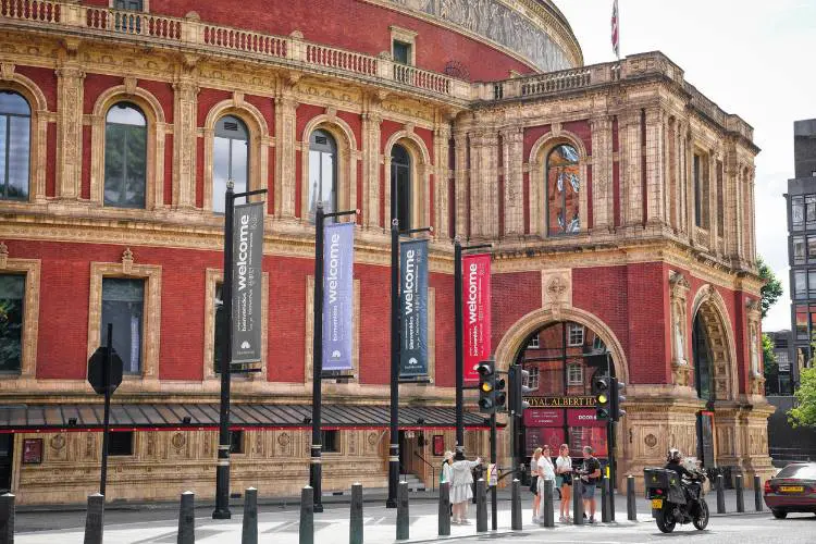 Pessoas caminhando em frente ao Royal Albert Hall.